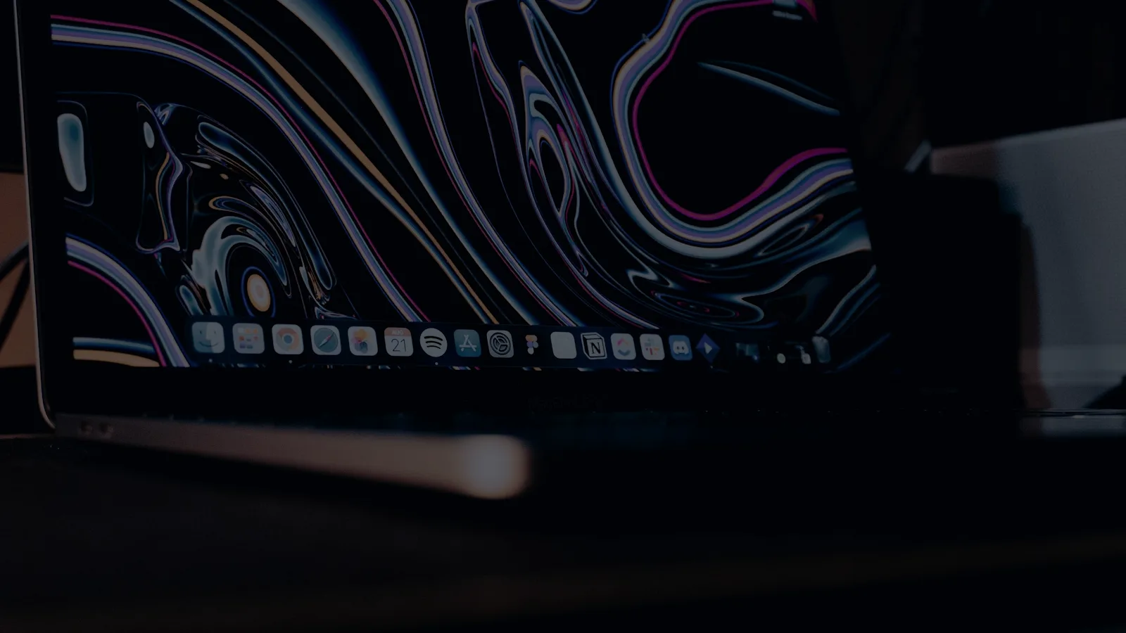 Laptop screen on a dark desk